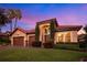 Stunning home with tile roof and two-car garage at sunset at 684 Sanctuary Golf, Apopka, FL 32712