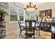 Charming breakfast nook with a round table and four chairs near a window at 684 Sanctuary Golf, Apopka, FL 32712