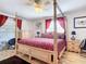 Main bedroom featuring a post bed, red bedding, and ample closet space at 2281 E Union Cir, Deltona, FL 32725