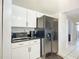Kitchen features white cabinets, black appliances, and a granite countertop at 2281 E Union Cir, Deltona, FL 32725