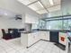 Spacious kitchen with white cabinets, black appliances, and a breakfast bar at 2281 E Union Cir, Deltona, FL 32725