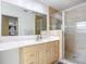 Bathroom with light wood vanity, large mirror and walk-in shower at 2281 E Union Cir, Deltona, FL 32725