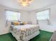 Bright bedroom with double bed, green carpet, and ample closet space at 2281 E Union Cir, Deltona, FL 32725