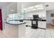 L-shaped kitchen with breakfast bar, white cabinets, and black appliances at 2281 E Union Cir, Deltona, FL 32725