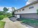 View of the side of the house and garage with a long driveway at 2281 E Union Cir, Deltona, FL 32725