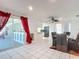 Dining room with glass table and chairs, view into the kitchen and backyard at 2281 E Union Cir, Deltona, FL 32725