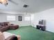 Large bonus room with green carpet and ceiling fan at 2281 E Union Cir, Deltona, FL 32725