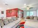 Living room with two sofas, an ottoman, and a red accent rug at 2281 E Union Cir, Deltona, FL 32725