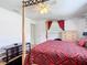 King-size bed in main bedroom with red bedding and wooden dresser at 2281 E Union Cir, Deltona, FL 32725
