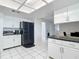 View of a kitchen with white cabinets and black appliances at 2281 E Union Cir, Deltona, FL 32725