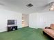 Bright living room featuring green carpet and a view into the kitchen at 2281 E Union Cir, Deltona, FL 32725