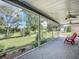 Relaxing screened porch with two chairs, overlooking a grassy yard at 2281 E Union Cir, Deltona, FL 32725