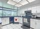 Modern kitchen with white cabinets, black appliances, and a large window at 2281 E Union Cir, Deltona, FL 32725