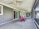 Relaxing screened porch with ceiling fans and red chairs at 2281 E Union Cir, Deltona, FL 32725