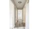Bright hallway with wood-look flooring and access to bedrooms at 507 Francis Blvd, Lakeland, FL 33801