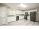 Modern kitchen with white shaker cabinets, granite countertops, and stainless steel appliances at 507 Francis Blvd, Lakeland, FL 33801