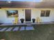 Inviting front porch with yellow chairs and a welcome mat at 4720 Sw 22Nd Pl, Ocala, FL 34474