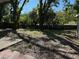 Large, mostly unlandscaped backyard with mature trees and a wood fence at 5146 Liming Ave, Orlando, FL 32808