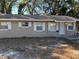 Tan single story house with white trim and a small front yard at 5146 Liming Ave, Orlando, FL 32808