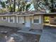 Tan single story house with white trim, covered carport, and small front yard at 5146 Liming Ave, Orlando, FL 32808