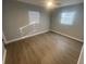 Bright bedroom featuring wood-look floors and neutral decor at 5146 Liming Ave, Orlando, FL 32808