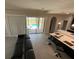 Living room with view of pool through sliding doors at 226 Macaulays Cv, Haines City, FL 33844