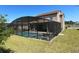 Screened pool and spa with patio furniture in backyard at 226 Macaulays Cv, Haines City, FL 33844