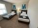Two twin beds in a bright and airy bedroom at 226 Macaulays Cv, Haines City, FL 33844