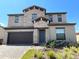 Two story home with stone and neutral siding at 226 Macaulays Cv, Haines City, FL 33844
