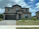 Two-story house with stone accents and a brown garage door at 226 Macaulays Cv, Haines City, FL 33844