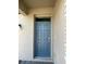 Modern two-toned front door with glass accents and sleek hardware at 226 Macaulays Cv, Haines City, FL 33844