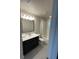 Bathroom with vanity, shower, and toilet, featuring dark brown cabinets at 226 Macaulays Cv, Haines City, FL 33844