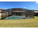 View of a refreshing screened pool and spa at 226 Macaulays Cv, Haines City, FL 33844