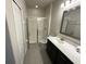 Clean bathroom with a shower, toilet, vanity, and dark cabinets at 226 Macaulays Cv, Haines City, FL 33844