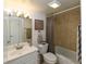 Bathroom with light beige tile and updated vanity at 204 Crown Oaks Way # 201, Longwood, FL 32779