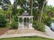 White gazebo with benches near a pond at 204 Crown Oaks Way # 201, Longwood, FL 32779