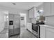 Modern kitchen with stainless steel appliances and white cabinets at 295 S Oak Ave, Bartow, FL 33830