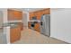 Kitchen with wood cabinets, stainless steel appliances, and tile floor at 1760 Travertine Ter, Sanford, FL 32771