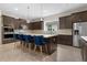 Modern kitchen with dark cabinetry, stainless steel appliances and quartz countertops at 14895 Winkfield Ct, Winter Garden, FL 34787