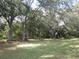 Private backyard with mature trees offering shade at 11540 Sandy Hill Dr, Orlando, FL 32821