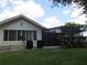 Home exterior with a screened enclosure and landscaped yard at 11540 Sandy Hill Dr, Orlando, FL 32821