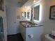 Modern bathroom with granite countertop, double sinks, and updated cabinets at 11540 Sandy Hill Dr, Orlando, FL 32821
