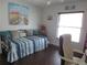 Bedroom with daybed, wood floors, and large window at 11540 Sandy Hill Dr, Orlando, FL 32821