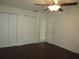 Bedroom featuring dark laminate floors, double closets and access to bathroom at 11540 Sandy Hill Dr, Orlando, FL 32821