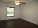 Bedroom with dark laminate wood flooring and ceiling fan at 11540 Sandy Hill Dr, Orlando, FL 32821