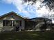 Home exterior showcasing a screened patio and lawn at 11540 Sandy Hill Dr, Orlando, FL 32821