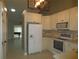 Modern kitchen with white cabinets and stainless steel appliances at 11540 Sandy Hill Dr, Orlando, FL 32821