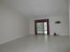 Large living room with tile floors and sliding doors at 11540 Sandy Hill Dr, Orlando, FL 32821