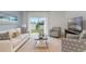 Bright living room featuring comfy seating, a large TV, and sliding glass doors leading to the backyard at 2924 Waterlily Way, Poinciana, FL 34759