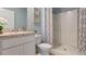 Clean bathroom with a shower/tub combo, a vanity, and neutral colors at 2924 Waterlily Way, Poinciana, FL 34759
